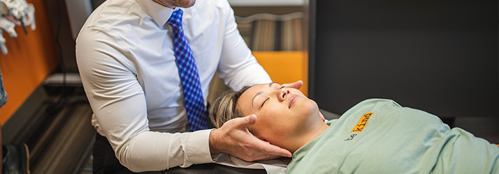 Chiropractor St Paul MN Jeremy Hurkman Adjusting Patient With Neck Pain